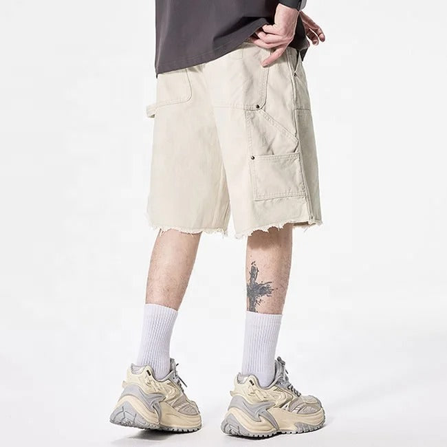 Beige cargo shorts with utility pockets and raw hem