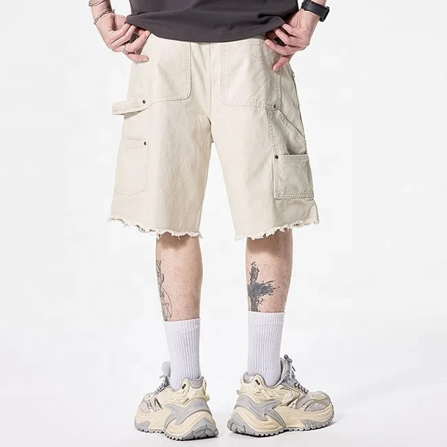 Beige cargo shorts with utility pockets and raw hem