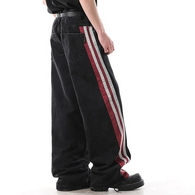 Black wide-leg jeans with red and white side stripe panels