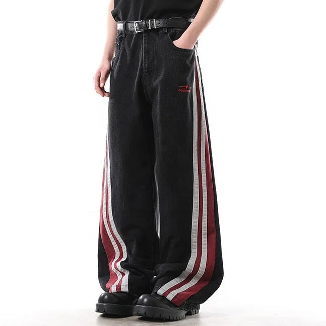 Black wide-leg jeans with red and white side stripe panels