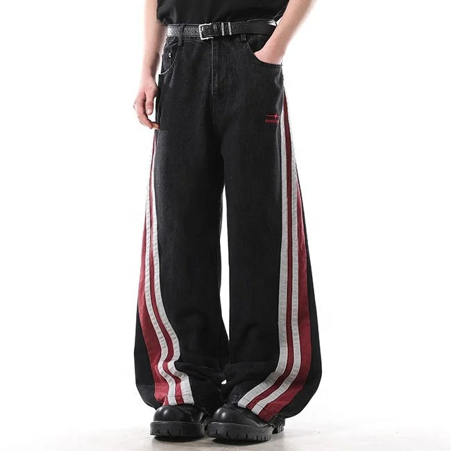 Black wide-leg jeans with red and white side stripe panels