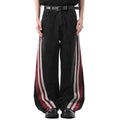 Black wide-leg jeans with red and white side stripe panels