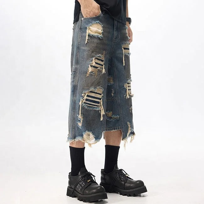 Dark blue distressed denim shorts with ripped detailing