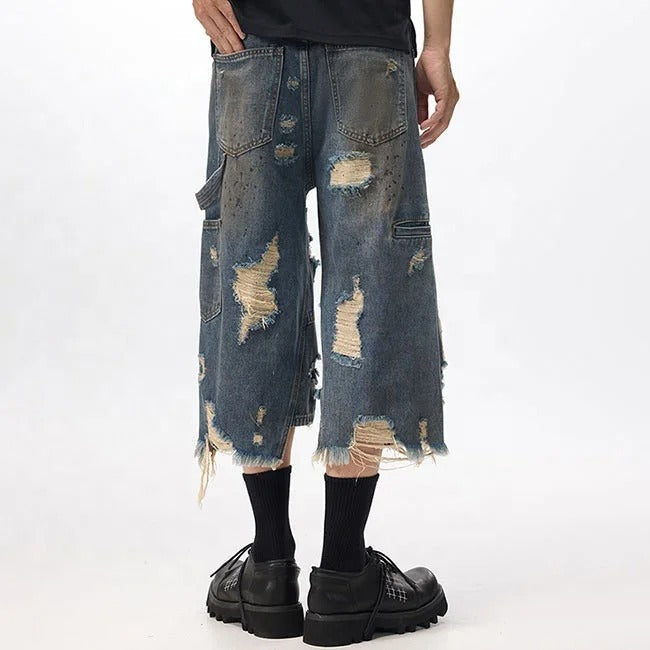 Dark blue distressed denim shorts with ripped detailing