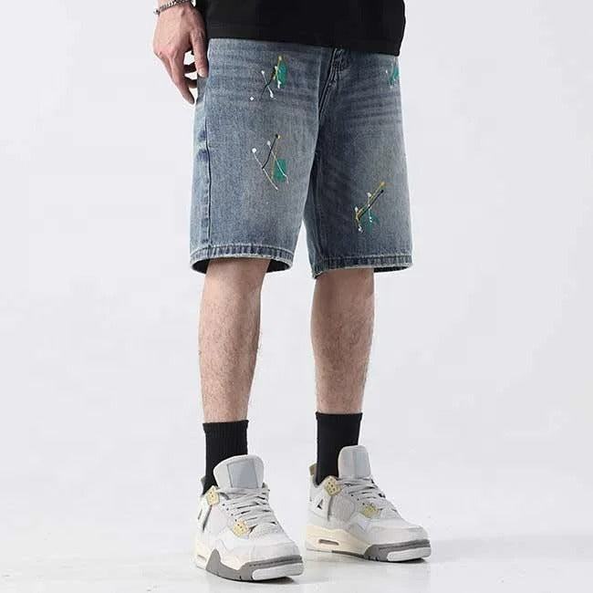 Light blue denim shorts with paint splatter detailing