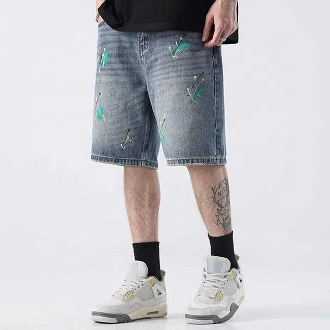 Light blue denim shorts with paint splatter detailing