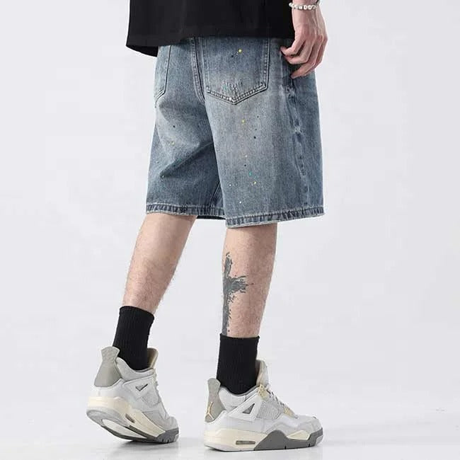 Light blue denim shorts with paint splatter detailing