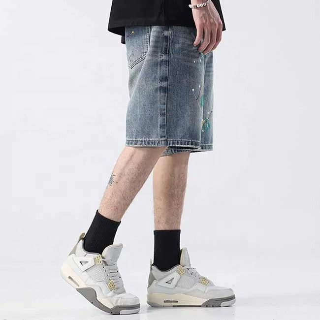 Light blue denim shorts with paint splatter detailing