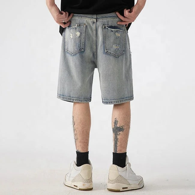 Light blue distressed denim shorts with ripped detailing