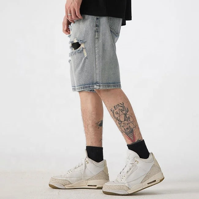 Light blue distressed denim shorts with ripped detailing