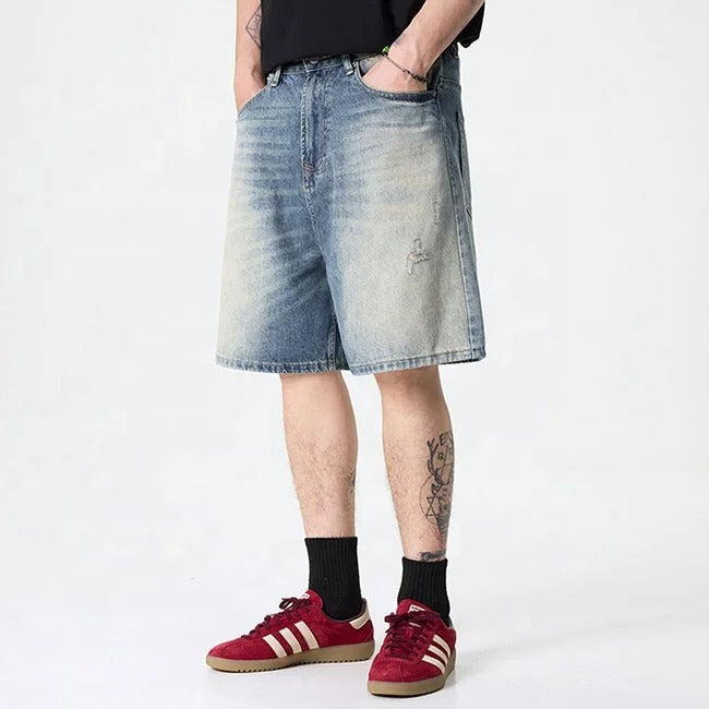 Light blue washed denim shorts with gradient fade