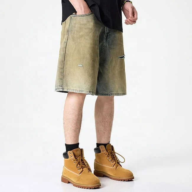 Olive green washed denim shorts with subtle distressing